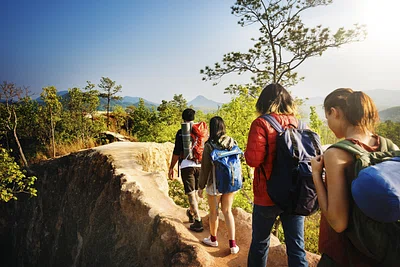 A group of people hiking a mountain ridge.